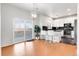 Eat-in kitchen features stainless appliances, granite counters and white cabinets, open to the dining area at 13181 Grant W Cir # B, Thornton, CO 80241