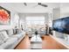 Bright living room boasts hardwood floors, a fireplace, and modern furnishings with a view of the outdoors at 13181 Grant W Cir # B, Thornton, CO 80241