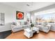 Bright living room boasts hardwood floors, a fireplace, and modern furnishings with a view of the outdoors at 13181 Grant W Cir # B, Thornton, CO 80241