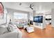 Bright living room boasts hardwood floors, a fireplace, and modern furnishings with a view of the outdoors at 13181 Grant W Cir # B, Thornton, CO 80241