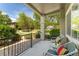 Relaxing balcony with chairs, table, and vibrant pillows overlooking the well-maintained community landscape at 2239 Calais Dr # 11F, Longmont, CO 80504