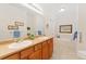 Bright bathroom featuring double sinks, a large mirror, vanity, and soaking tub at 2239 Calais Dr # 11F, Longmont, CO 80504