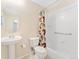 Well-lit bathroom features a pedestal sink and shower with modern fixtures at 2239 Calais Dr # 11F, Longmont, CO 80504