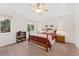 Comfortable bedroom featuring a ceiling fan, a wooden bed frame, bedside lamps, and a window at 2239 Calais Dr # 11F, Longmont, CO 80504