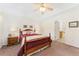 Comfortable bedroom featuring a ceiling fan, a wooden bed frame, bedside lamps, and an ensuite bathroom at 2239 Calais Dr # 11F, Longmont, CO 80504