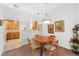 Cozy dining area featuring a round wood table, seating for four, and view of the kitchen at 2239 Calais Dr # 11F, Longmont, CO 80504