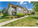Beautiful condominium complex exterior showing well-manicured landscaping and inviting walkways at 2239 Calais Dr # 11F, Longmont, CO 80504