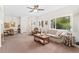 Bright living room with large windows, neutral carpet, comfortable seating, and an adjacent dining area at 2239 Calais Dr # 11F, Longmont, CO 80504