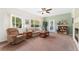 Cozy living room featuring large windows, a ceiling fan, comfortable seating, and natural light at 2239 Calais Dr # 11F, Longmont, CO 80504