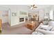 Inviting living room featuring a fireplace, cozy seating, and an open layout to the dining area at 2239 Calais Dr # 11F, Longmont, CO 80504