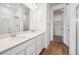 Bright bathroom features a double vanity with modern fixtures and a walk-in closet at 6616 N Nepal St, Aurora, CO 80019