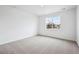 Neutral bedroom featuring carpet, a large window, and neutral colored walls at 6616 N Nepal St, Aurora, CO 80019