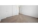 Carpeted bedroom with double closet and open doorway at 6616 N Nepal St, Aurora, CO 80019