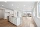 Open-concept kitchen with white cabinets, stainless steel appliances, and lots of natural light at 6616 N Nepal St, Aurora, CO 80019