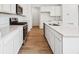 Modern kitchen with white cabinets, stainless steel appliances, and quartz countertops at 6616 N Nepal St, Aurora, CO 80019