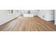 Open-concept living space featuring new flooring, neutral walls, recessed lighting, and an island with sink at 6616 N Nepal St, Aurora, CO 80019