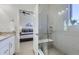 Modern bathroom with glass shower, bench seat and a view into the bedroom at 2214 Central Park Way, Superior, CO 80027
