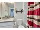 Well-lit bathroom featuring a floating shelf and modern fixtures at 2214 Central Park Way, Superior, CO 80027