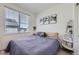 Neutral bedroom features a large window with natural light and modern decor at 2214 Central Park Way, Superior, CO 80027