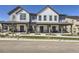 Exterior view of modern townhomes with covered porches and professional landscaping at 2214 Central Park Way, Superior, CO 80027