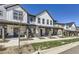 Well-maintained townhomes featuring neutral tones, covered porches, and manicured lawns at 2214 Central Park Way, Superior, CO 80027