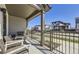 Cozy covered front porch with seating and a view of the street at 2214 Central Park Way, Superior, CO 80027