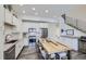Modern kitchen with stainless steel appliances and rustic wooden table at 2214 Central Park Way, Superior, CO 80027