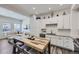 Bright modern kitchen flowing into open living room with seating area at 2214 Central Park Way, Superior, CO 80027