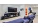 Basement living room features reclining loveseat and media center at 2214 Central Park Way, Superior, CO 80027