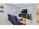 Basement living room features reclining loveseat and media center at 2214 Central Park Way, Superior, CO 80027