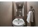 Powder room featuring modern fixtures, neutral wall color, and decorative mirror above the sink at 10752 Steele St, Northglenn, CO 80233