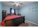 Bedroom featuring a bed, window with blinds, and blue walls at 10752 Steele St, Northglenn, CO 80233