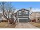 Charming two-story home featuring a gray exterior, attached garage, and well-maintained front yard at 10752 Steele St, Northglenn, CO 80233