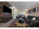 Stylish living room featuring a wood-paneled accent wall with fireplace and modern decor at 10752 Steele St, Northglenn, CO 80233