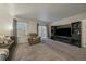 Spacious living room with a comfortable seating area, built-in shelving, and sliding glass doors to a patio at 10752 Steele St, Northglenn, CO 80233