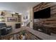 Bright living room with a cozy fireplace, rustic wood accents, and comfortable seating at 10752 Steele St, Northglenn, CO 80233