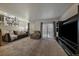 Cozy living room featuring a comfortable sofa, a large TV, and natural light at 10752 Steele St, Northglenn, CO 80233