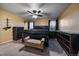 Spacious main bedroom featuring a ceiling fan, two windows, and black furniture at 10752 Steele St, Northglenn, CO 80233