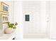 Bathroom featuring a pristine white tiled wall, tub, and elegant decorative elements at 1140 Devonshire Ct, Lafayette, CO 80026