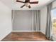 An empty bedroom featuring stylish tree-themed wall decals and a modern ceiling fan at 1140 Devonshire Ct, Lafayette, CO 80026