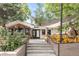 Inviting view of the 'Ghost Box' building exterior, featuring a patio, string lights, and modern design at 1140 Devonshire Ct, Lafayette, CO 80026