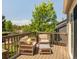 Outdoor deck with comfortable seating, perfect for enjoying the surrounding lush greenery at 1140 Devonshire Ct, Lafayette, CO 80026