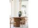 Bright dining area with modern wood table, neutral decor and backyard access at 1140 Devonshire Ct, Lafayette, CO 80026
