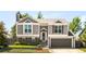 Charming two-story home with gray siding, brick accents, and well-manicured landscaping at 1140 Devonshire Ct, Lafayette, CO 80026