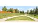 A grassy field and paved walking path provide room for recreational activities at 1140 Devonshire Ct, Lafayette, CO 80026