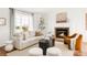 Cozy living room with fireplace, plush seating, and ample natural light at 1140 Devonshire Ct, Lafayette, CO 80026