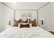 A serene bedroom featuring a plush bed adorned with decorative pillows and matching bedside lamps at 1140 Devonshire Ct, Lafayette, CO 80026