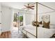 Bright, airy main bedroom with a canopy bed and a sliding glass door leading to a private deck at 1140 Devonshire Ct, Lafayette, CO 80026