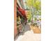 Sidewalk view of outdoor seating area with red awnings and storefront window displays at 1140 Devonshire Ct, Lafayette, CO 80026