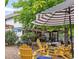 Picturesque outdoor seating area with yellow Adirondack chairs and a striped umbrella at 1140 Devonshire Ct, Lafayette, CO 80026